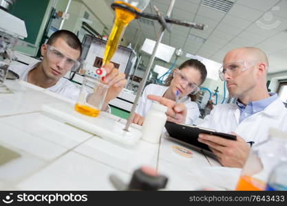 science students working with chemicals in lab at the university