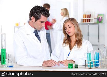 Science teacher helping student