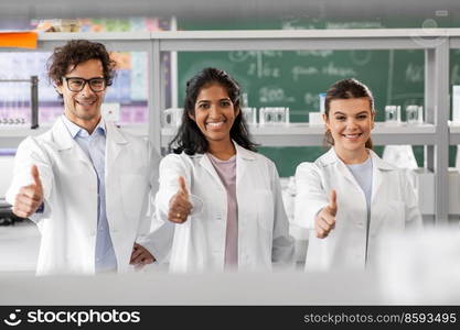 science, work and people concept - international group of happy scientists showing thumbs up in laboratory. happy scientists showing thumbs up in laboratory