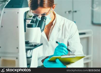 Scientific laboratory research Biotechnology scientist taking notes