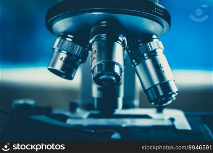 scientific microscope for biology research in laboratory, medicine microbiology or biotechnology technology equipment, coronavirus covid-19 vaccine development