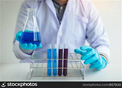 Scientific researcher holding chemical substance in laboratory.