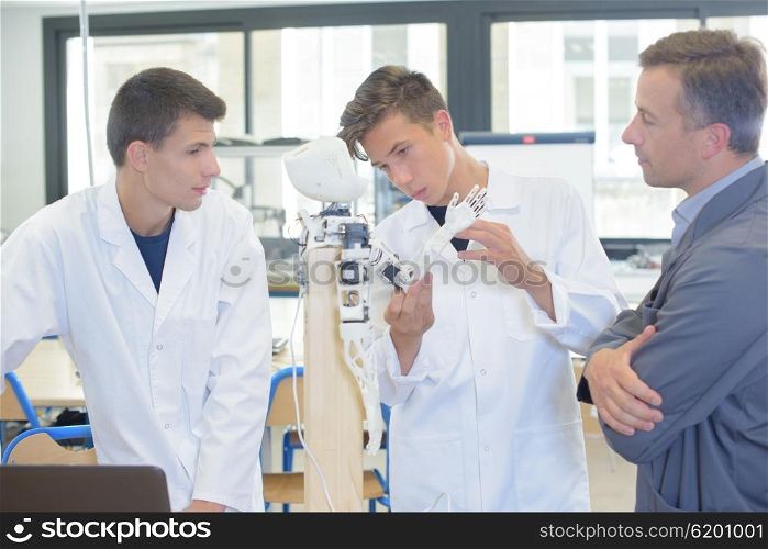 Scientific students showing an electronic device