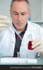 scientist analyzing blood test sample in laboratory