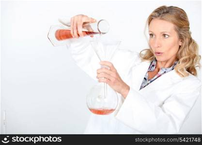 Scientist carefully mixing chemicals