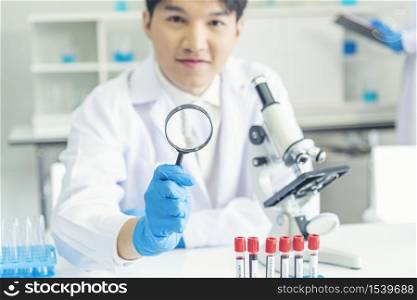 Scientist covid-19 virus antibody research laboratory research experiment biotech cultivate vaccine against virus. Scientist look at microscope experiment lab science test tube Chemistry laboratory