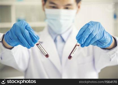 Scientist covid-19 virus antibody research laboratory research experiment biotech cultivate vaccine against virus. Scientist look at microscope experiment lab science test tube Chemistry laboratory