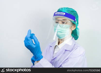 Scientist doctor wearing face mask, glasses or goggles and protective suit to fight coronavirus pandemic Covid-19, coronavirus pandemic threat quarantine, medical and healthcare concept