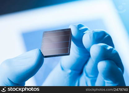 Scientist hold in hand small tile of new type efficient solar cell tile, solar technology research concept