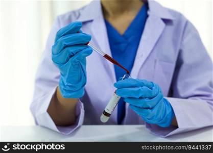 Scientist holding Coronavirus covid-19 infected blood s&le tube. DNA testing of the blood in the laboratory with blood s&le collection tubes and syringe Coronavirus Covid-19 vaccine research