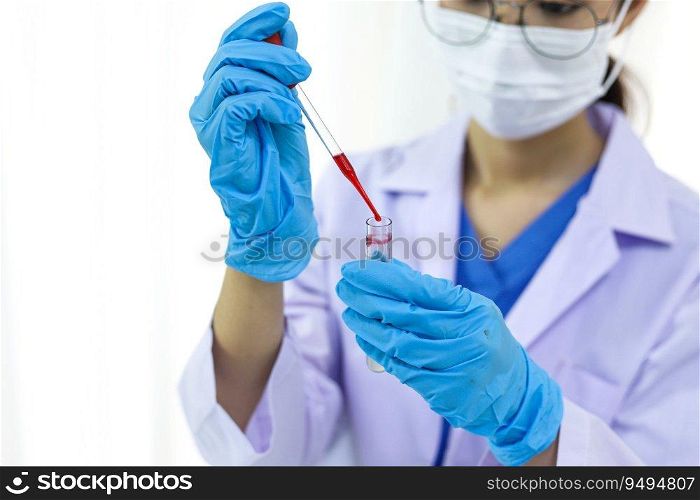 Scientist holding Coronavirus covid-19 infected blood s&le tube. DNA testing of the blood in the laboratory with blood s&le collection tubes and syringe Coronavirus Covid-19 vaccine research