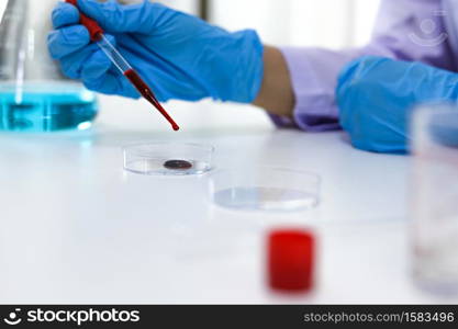 Scientist holding Coronavirus covid-19 infected blood sample tube. DNA testing of the blood in the laboratory with blood sample collection tubes and syringe Coronavirus Covid-19 vaccine research