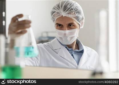 scientist holding flask close up