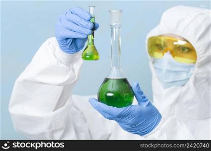 scientist holding green chemicals