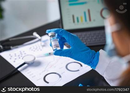 scientist holding vaccine after research in lab