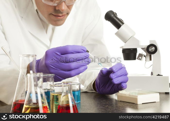 Scientist in his laboratory prepares a slide for the microscope.