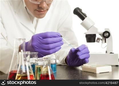 Scientist in his laboratory prepares a slide for the microscope.