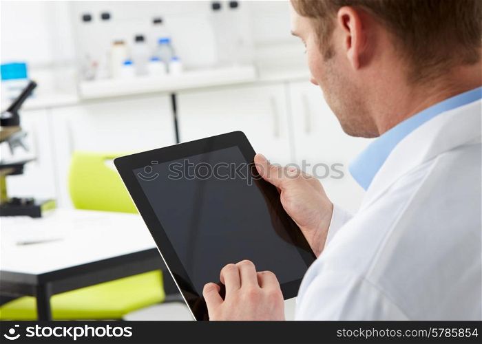 Scientist In Laboratory Using Digital Tablet