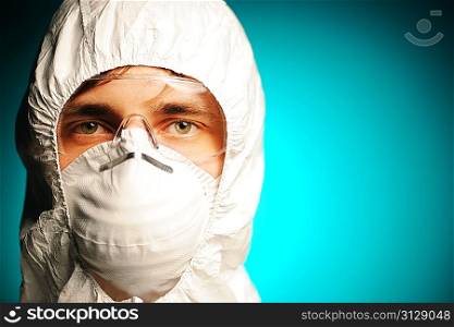 Scientist in protective wear, glasses and respirator