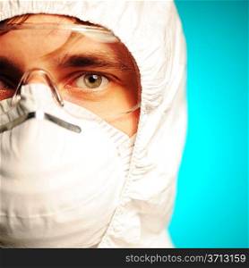 Scientist in protective wear, glasses and respirator
