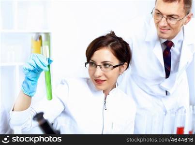 Scientist in uniform doing tests in laboratory