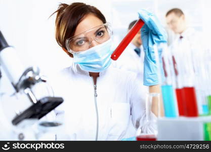 Scientist in uniform doing tests in laboratory