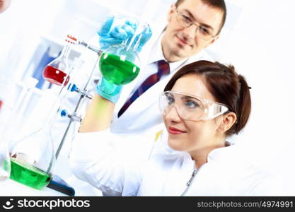 Scientist in uniform doing tests in laboratory