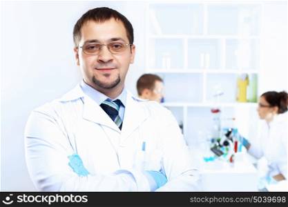 Scientist in uniform doing tests in laboratory
