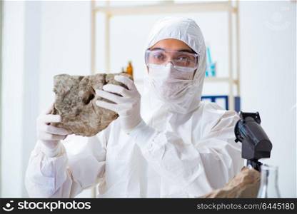 Scientist looking and stone samples in lab