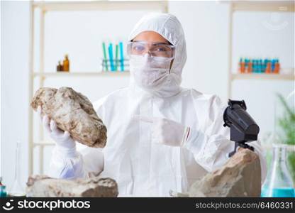 Scientist looking and stone samples in lab