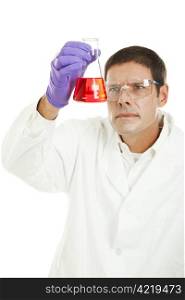Scientist looking at a chemical in a flask. Isolated on white. Focus on the flask.