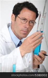 Scientist looking at test-tube