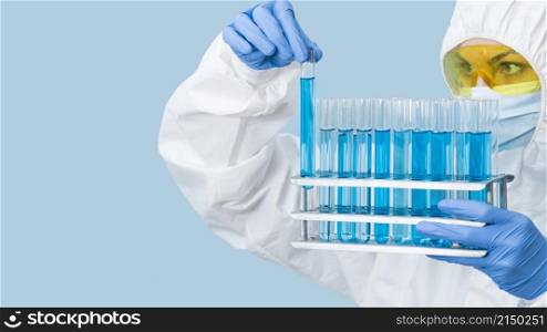 scientist looking blue chemicals