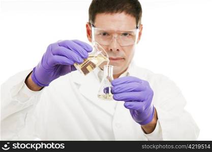 Scientist measures liquid as he pours it from a beaker to a flask. Shallow depth of field with focus on liquid.