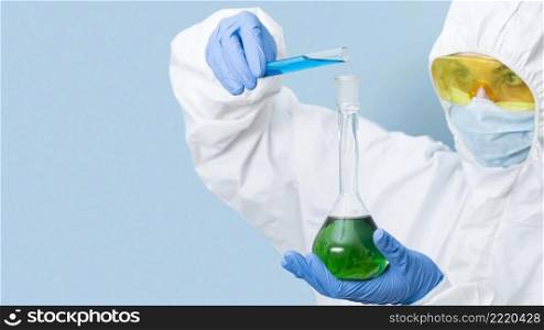 scientist mixing chemicals with copy space
