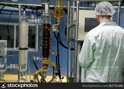 Scientist or apothecary extract CBD hemp oil for medical and healthcare purposes. Healthcare pharmacy from cannabis products. Cannabis oil extraction machine with glass tubes and equipmetns.. Scientist or apothecary in lab extract CBD hemp oil for medical purpose.