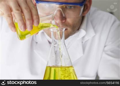 Scientist Pouring Liquid Into Flask