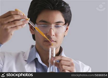 Scientist putting liquid in test tube