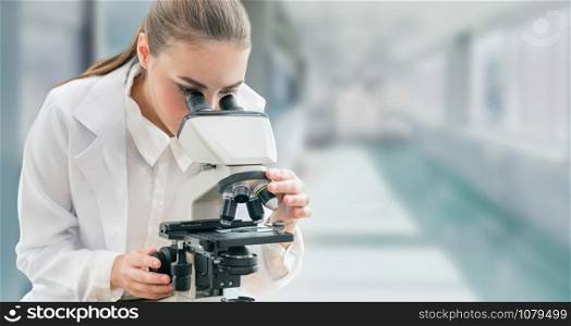 Scientist researcher using microscope in laboratory. Medical healthcare technology and pharmaceutical research and development concept.