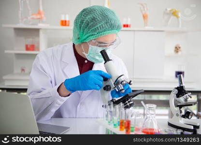 Scientist researcher using microscope in Laboratory. Scientist researcher virus on microscope.