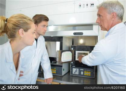Scientist taking product from cabinet