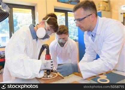 scientist teaching students in laboratory