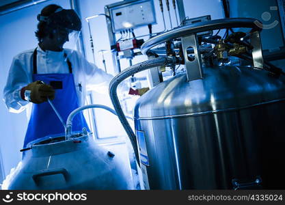 Scientist using gas tanks in lab