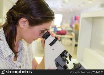 scientist using microscope in laboratory