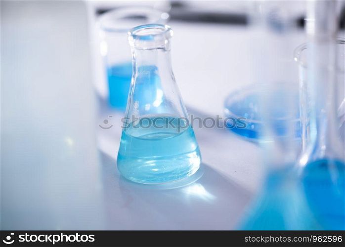 scientist with equipment and science experiments ,laboratory glassware containing chemical liquid for design or decorate science or other your content and selective focus