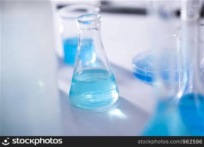 scientist with equipment and science experiments ,laboratory glassware containing chemical liquid for design or decorate science or other your content and selective focus