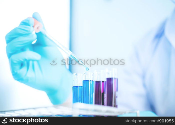 Scientist with equipment holding tools during scientific experiment science concept