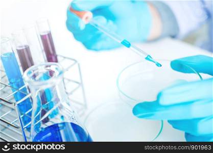 Scientist with equipment holding tools during scientific experiment science concept