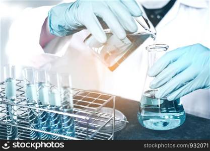 Scientist with equipment holding tools during scientific experiment science concept