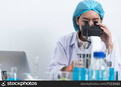 Scientists are using microscopes. For laboratory experiments